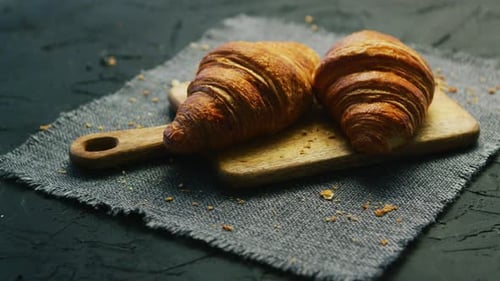 Delicious Croissants on a Wooden Board