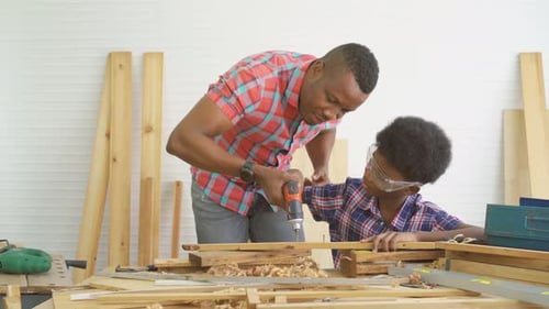 Man and Child Woodworking Together in Workshop