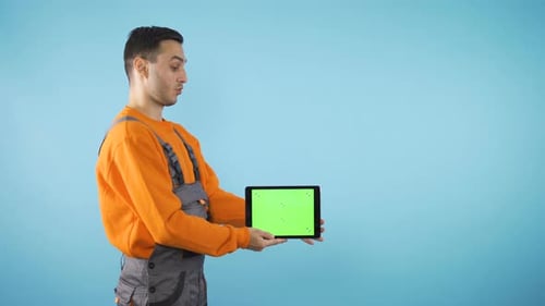 Man Holds Tablet With Chroma Key Background