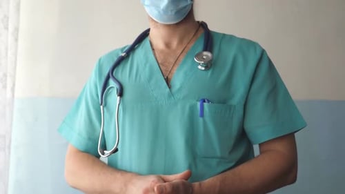 Medical Professional Wearing Scrubs and a Mask