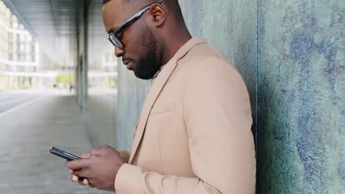 Man in Suit Using Phone Outdoors