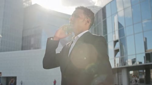 Man in Suit Speaking on Phone Outside