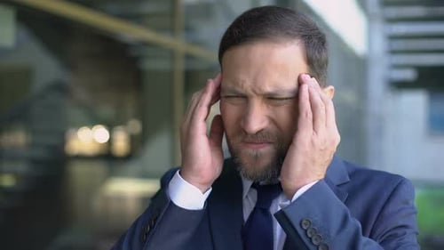 Stressed Male Employee Feeling Headache, Massaging Temples, City Noise, Crisis