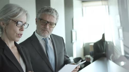 Business Professionals Discussing Data in Modern Office