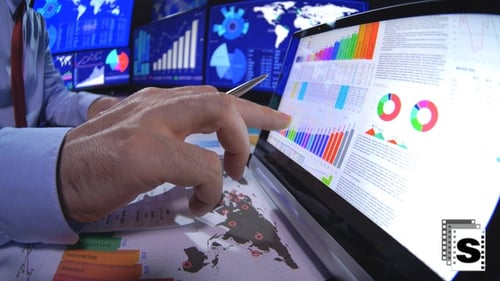 Financial Analyst Reviewing Business Data Charts and Graphs