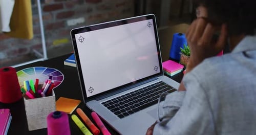 African american woman sitting in cafe using laptop and smiling