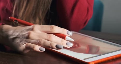Close Up Female Designer Sitting and Working at Desk. Contemporary Young Woman Drawing and Using Pen