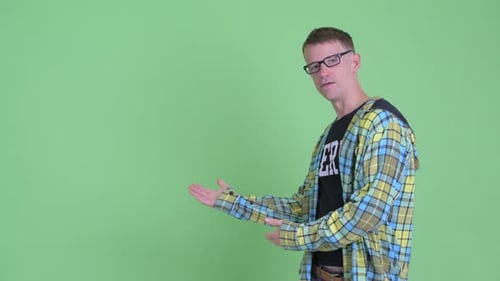 Young Adult Presents Against Green Screen Backdrop