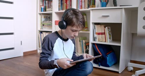 Boy Relaxing Using Digital Tablet at Home