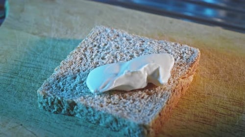 Spreading Low-Fat Cheese On Whole Grain Toast. close up