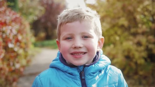 Close Up of Blond Boy Smiling Outdoors