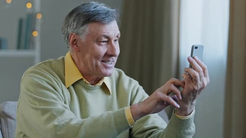 Smiling Senior Man Video Calling at Home