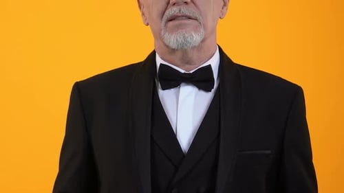 Man in Tuxedo Fanning US Hundred Dollar Bills