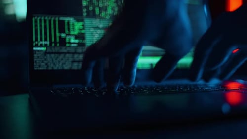 Hacker is Working on Laptop at Night