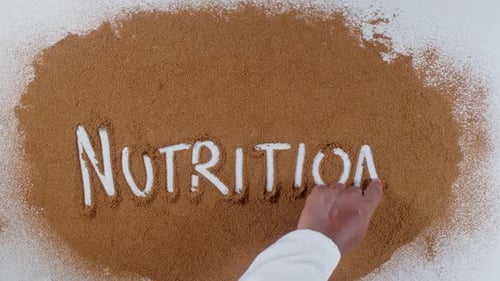 Writing 'Nutrition' in Cocoa Powder Top Down