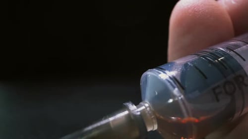 Close Up of Syringe Being Pressed