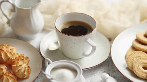 Side View of Delicious Dessert Served. Butter and Coconut Cookies with Cup of Black Coffee