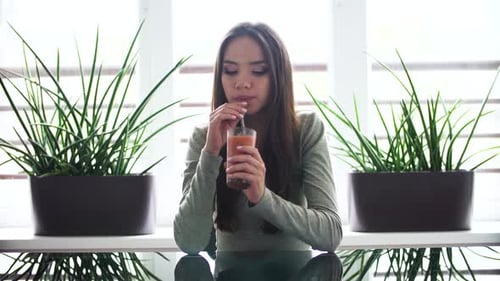 Woman Drinks Healthy Smoothie in Bright Home