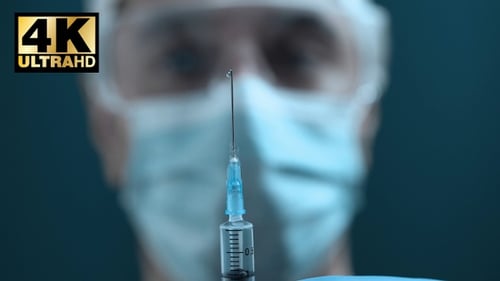 Close Up Medical Professional Holding Syringe
