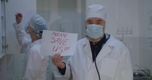 Doctor Holding Plea Sign in Hospital Room