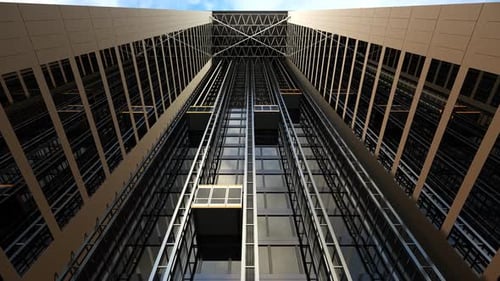 The modern building with the elevator shaft on the front of the facade.
