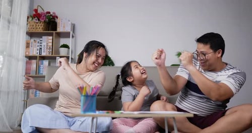Happy Family Dancing Together at Home