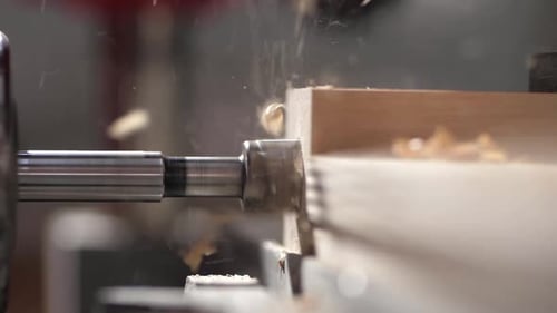 Drill Bit Cutting Through Wood Close Up