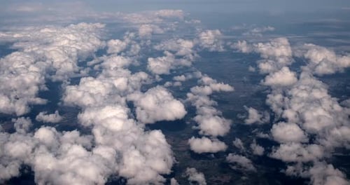 Aerial View of Fluffy Clouds over Green Landscape