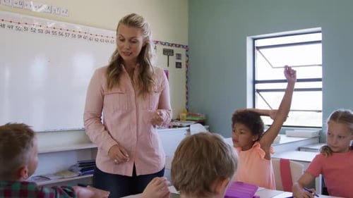 Elementary School Teacher With Children in Classroom