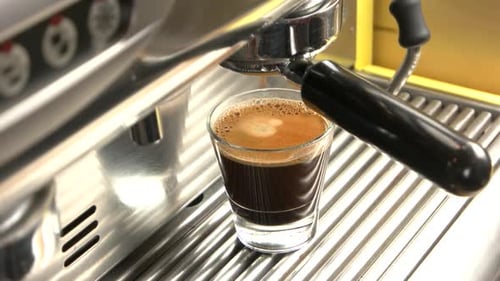 Pouring Fresh Espresso in Shiny Espresso Machine