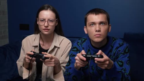 Young Couple Playing Video Games Indoors