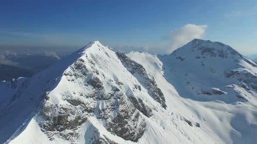 Aerial View of Snow-Capped Mountain Peaks in Winter