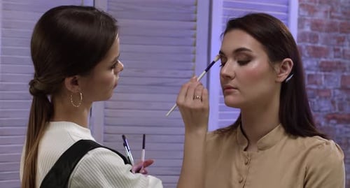 Make up artist applying eye shadow