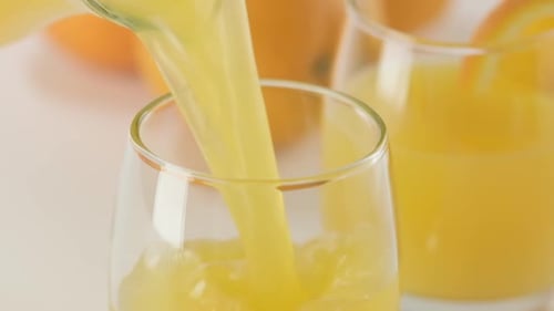 Fresh Orange Juice Being Poured in Glass