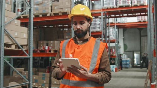 Worker with Tablet Stocktaking in Warehouse