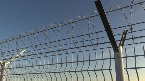 Top of Barbed Wire Fence Against Sky