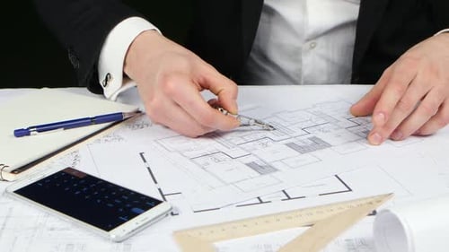 Businessman Makes Calculations and Checks the Correctness of the Drawing. Close Up