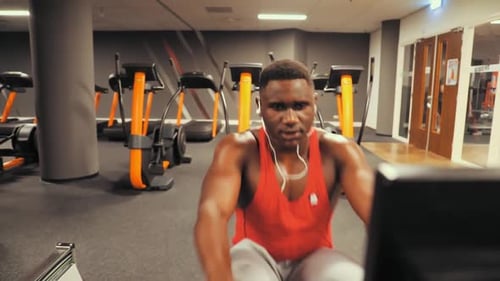 A man rowing in the gym.