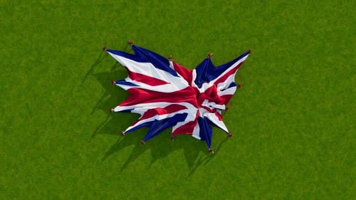 Union Jack Flag Unfurling on Green Grass Background