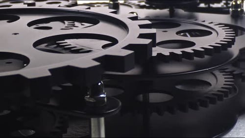 Intricate Black Gears Turning in Close Up