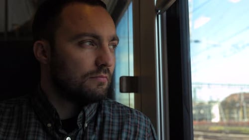 Handsome Guy on Train Looking Out the Window