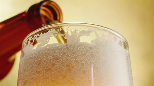 Amber Beer Being Poured into Glass Close Up