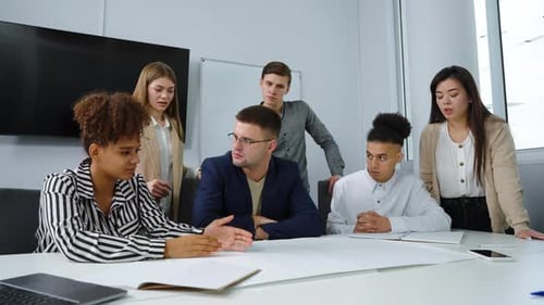 Group of Designers Discussing Scheme in Office