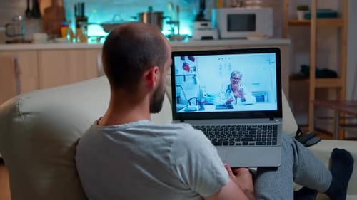 Man Telehealth Appointment with Doctor on Laptop