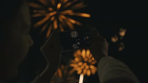Filming Fireworks Display with Mobile Phone at Night