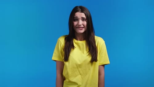 Concerned Woman Gesturing on Blue Background