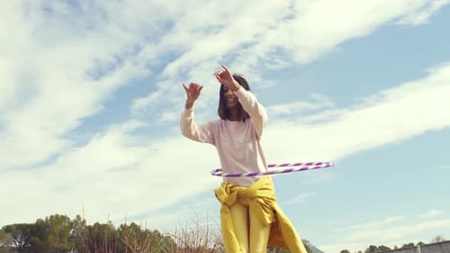 Woman Hula Hooping Outside on Sunny Day