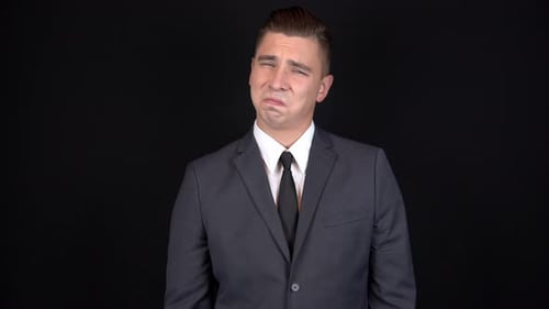 Man in Suit Expressing Disgust and Rejection