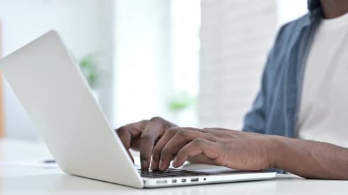 Close Up Young African Man Hand Working on Laptop