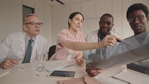 Medical Professionals Reviewing X-Ray in Office Setting
